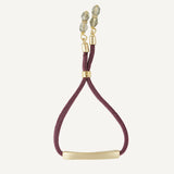 Pulsera para mujer elástica color berenjena con pieza dorada