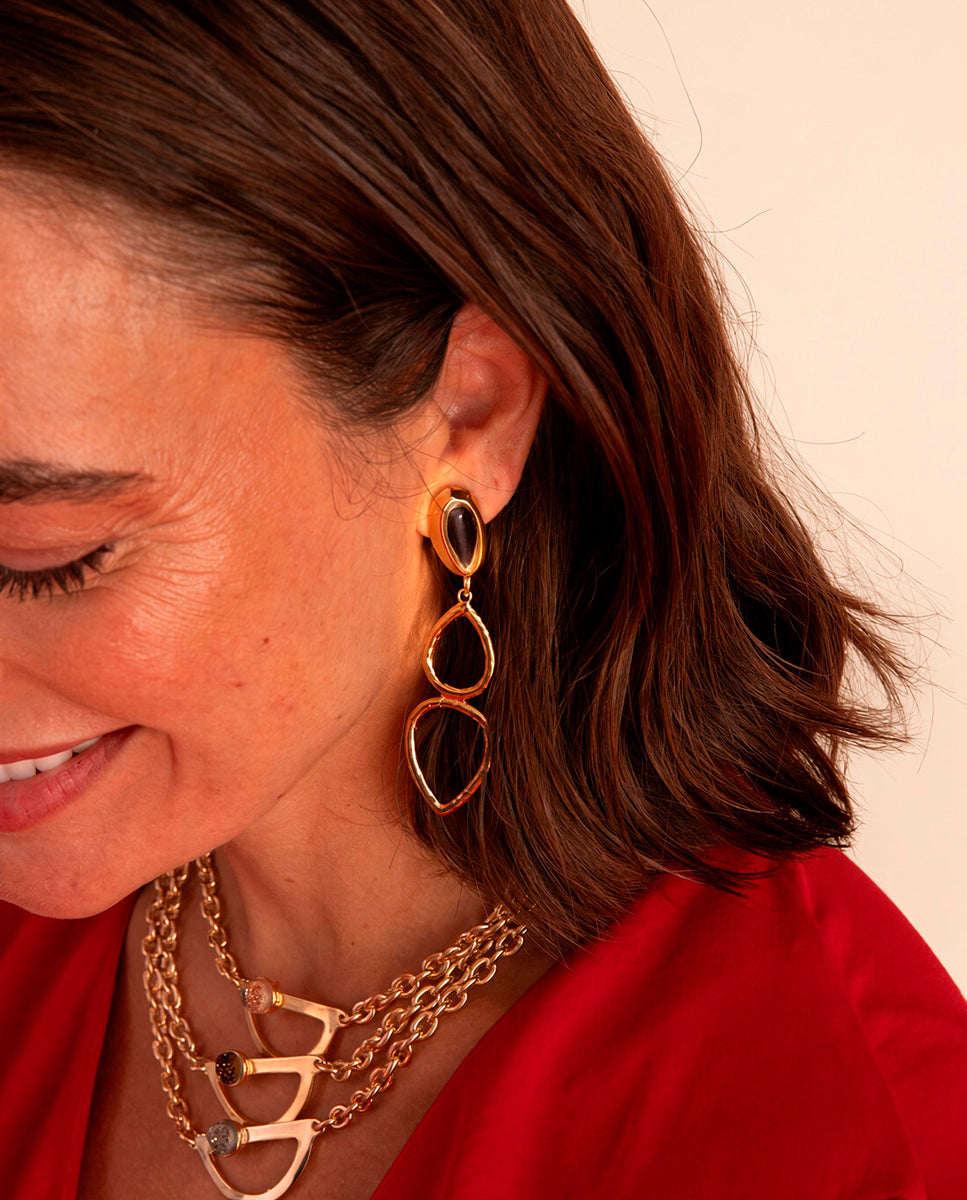 Model wearing Emolo Teardrop long earrings with an oval stone and gold teardrop hoops