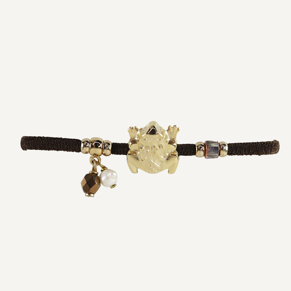 Pulsera elástica para mujer con pieza dorada con forma de rana