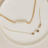 collar de cadena con perlas y estrellas