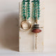 Emolo ODRI MUSHA necklace in bottle green and brown, with gold ring and pendant