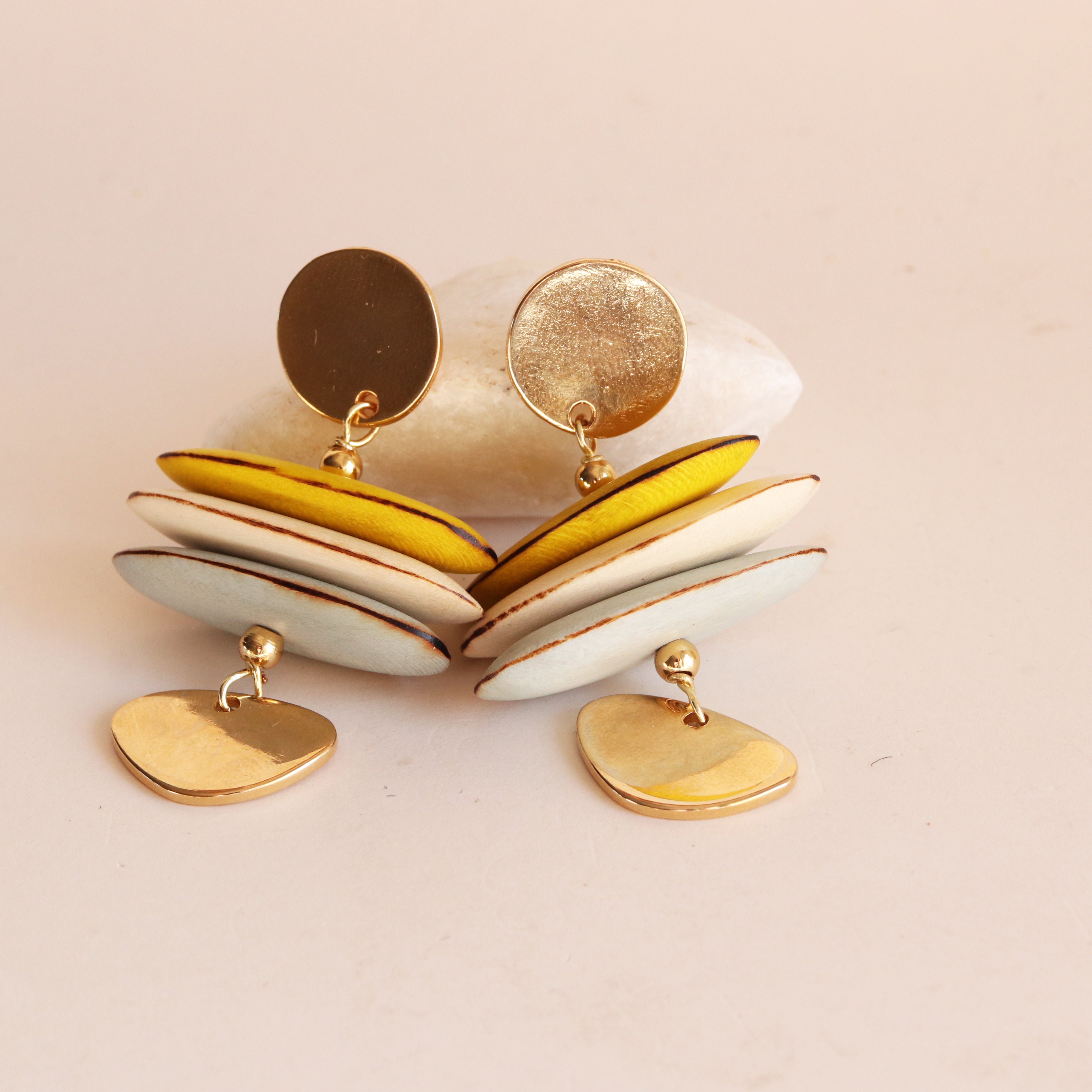 Close-up of the Macao earrings in yellow, wooden beads and gold plating — Émolo