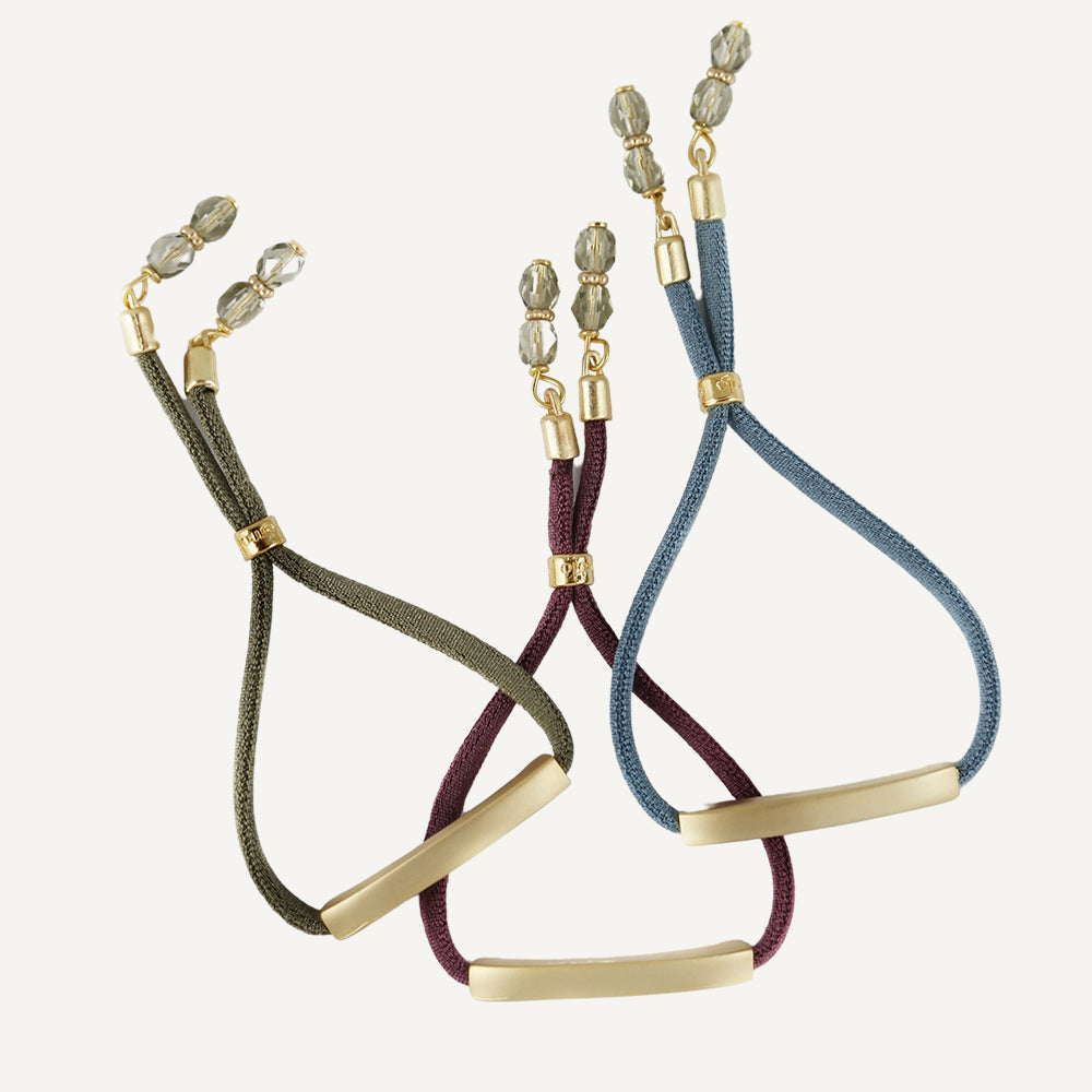 Adjustable bracelets for women with a rectangular gold-tone piece.